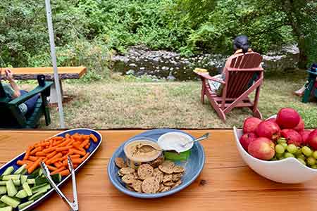 Yoga students relaxing by the creek at yoga retreat