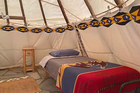 Comfortable glamping style beds in tents and tipis