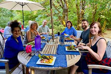 Outdoor dining and community gathering at yoga retreat